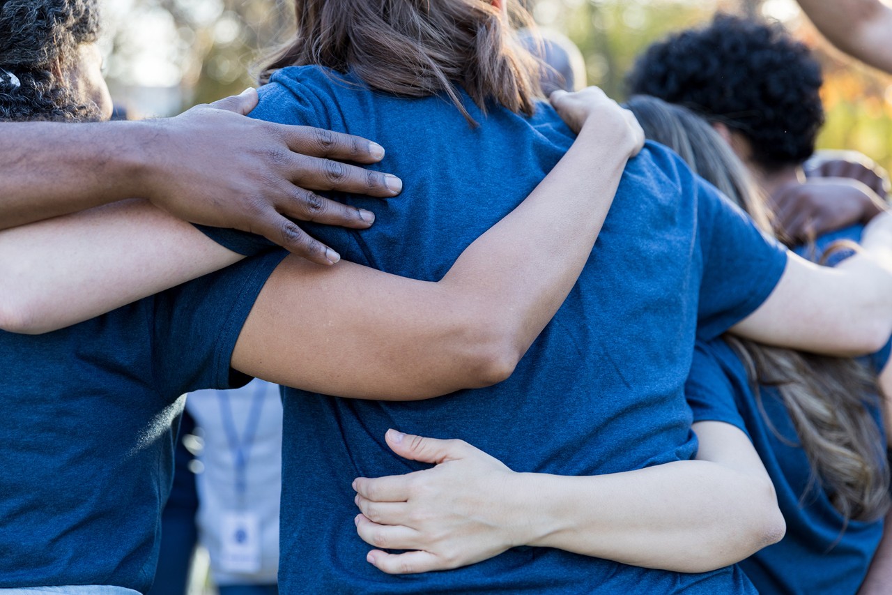 A team holding each other